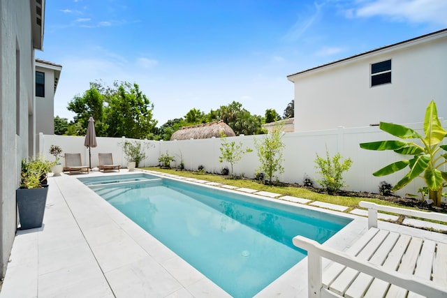 7102 Rockwood Rd, Jupiter, FL 33458 - view of swimming pool featuring a fenced backyard, a pool with connected hot tub, and a patio
