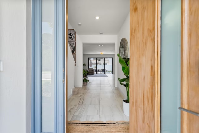 7102 Rockwood Rd, Jupiter, FL 33458 - hall with marble look tiles and recessed lighting