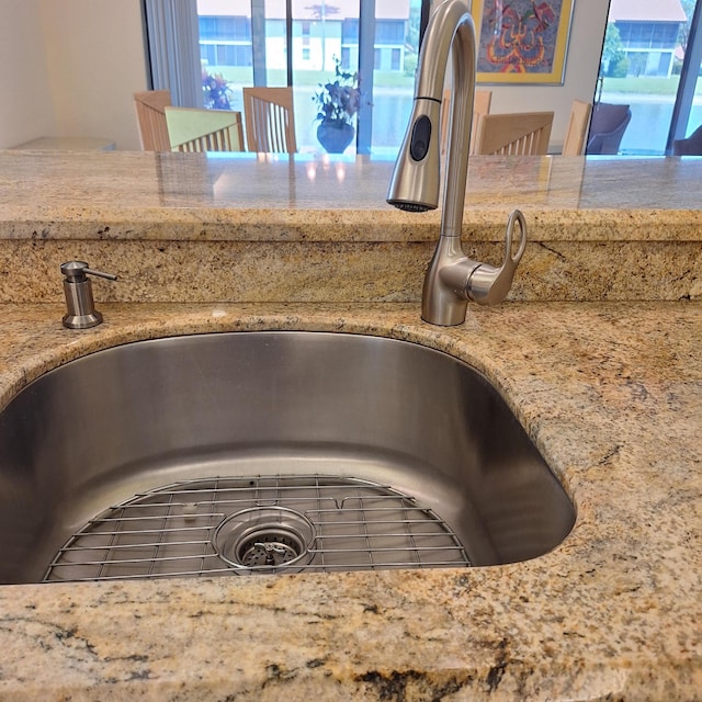 10231 N Circle Lake Dr Unit 101, Boynton Beach, FL 33437 - kitchen view of a sink and light stone counters