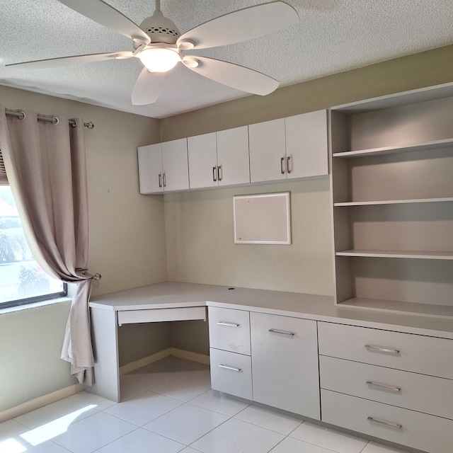 10231 N Circle Lake Dr Unit 101, Boynton Beach, FL 33437 - unfurnished office featuring built in desk, light tile patterned flooring, a textured ceiling, and a ceiling fan