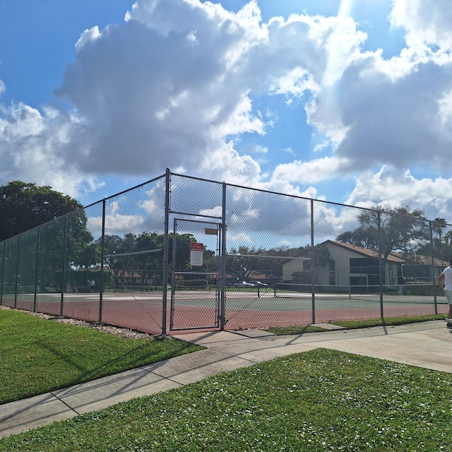 10231 N Circle Lake Dr Unit 101, Boynton Beach, FL 33437 - view of tennis court with a gate
