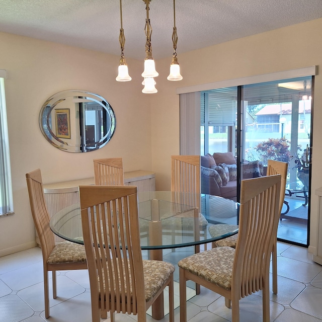 10231 N Circle Lake Dr Unit 101, Boynton Beach, FL 33437 - dining space featuring a textured ceiling