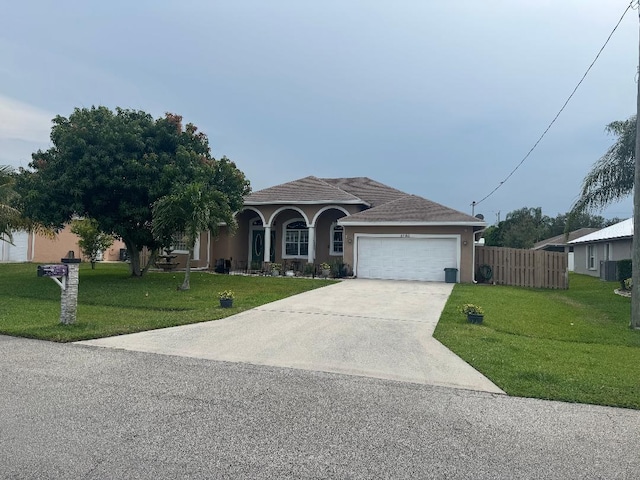 5760 NW Cleburn Dr, Port Saint Lucie, FL 34986 - view of front of house with a garage, driveway, and stucco siding