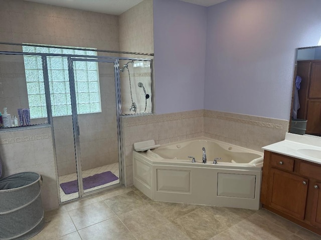 5760 NW Cleburn Dr, Port Saint Lucie, FL 34986 - full bath featuring a whirlpool tub, a stall shower, vanity, and tile patterned flooring