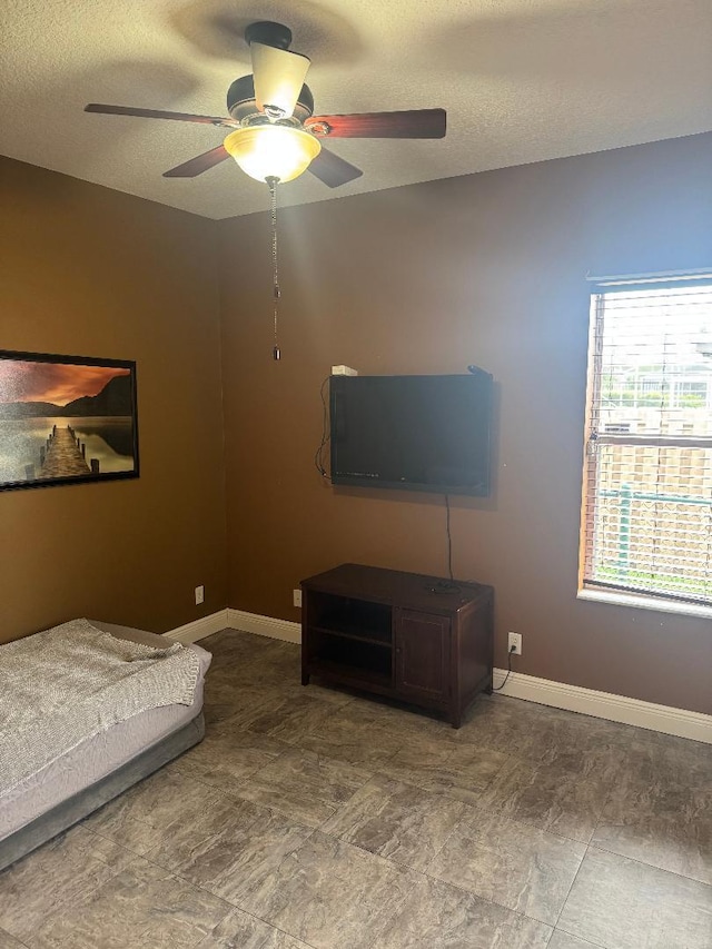 5760 NW Cleburn Dr, Port Saint Lucie, FL 34986 - bedroom with ceiling fan, a textured ceiling, and baseboards