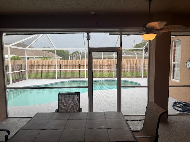 5760 NW Cleburn Dr, Port Saint Lucie, FL 34986 - view of pool featuring a fenced backyard, glass enclosure, a patio, and a ceiling fan