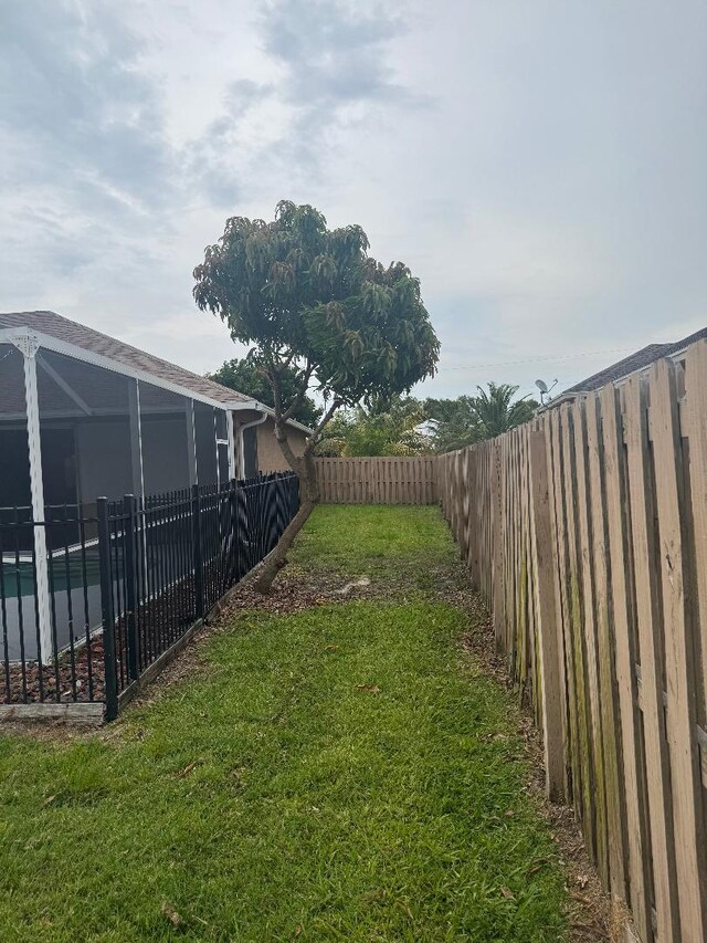 5760 NW Cleburn Dr, Port Saint Lucie, FL 34986 - view of yard featuring a lanai