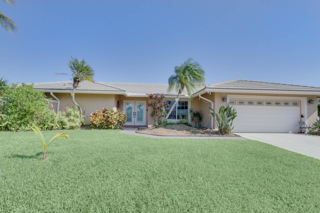 1855 Lotus Ln, Wellington, FL 33414 - ranch-style home featuring french doors, a garage, a front lawn, stucco siding, and concrete driveway