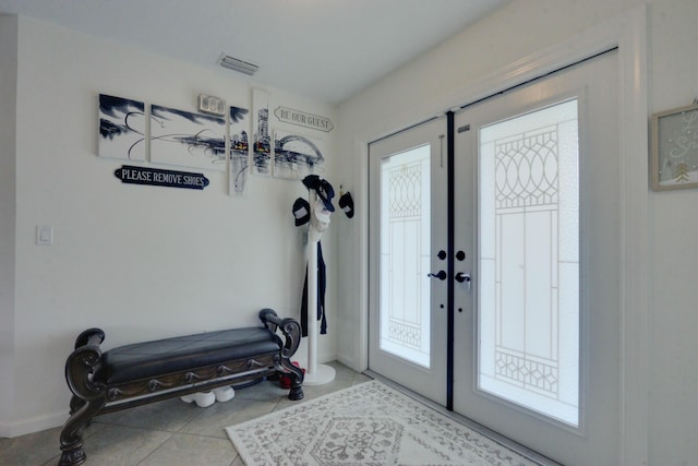 1855 Lotus Ln, Wellington, FL 33414 - entrance foyer featuring plenty of natural light, baseboards, tile patterned floors, and french doors