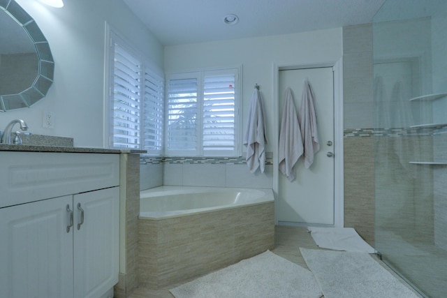 1855 Lotus Ln, Wellington, FL 33414 - bathroom with a garden tub, vanity, tiled shower, and tile patterned flooring