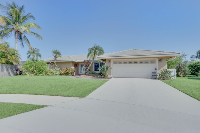 1855 Lotus Ln, Wellington, FL 33414 - ranch-style home featuring an attached garage, driveway, a front yard, and stucco siding