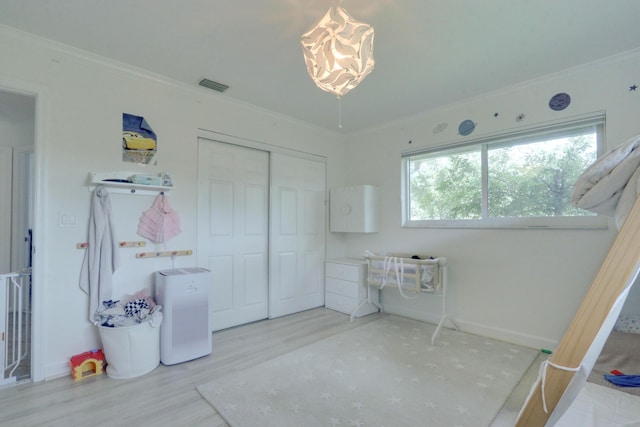 1855 Lotus Ln, Wellington, FL 33414 - bedroom with wood finished floors, a closet, crown molding, baseboards, and a chandelier
