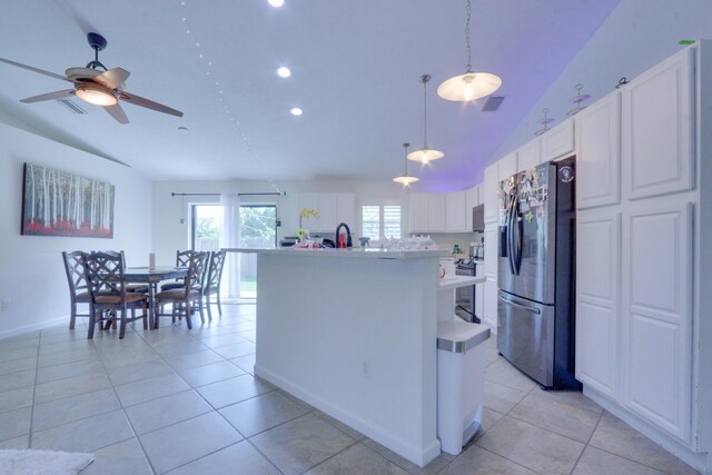 1855 Lotus Ln, Wellington, FL 33414 - kitchen with stainless steel refrigerator with ice dispenser, lofted ceiling, light countertops, white cabinets, and a kitchen island with sink