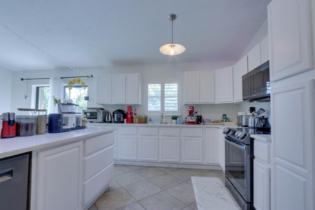 1855 Lotus Ln, Wellington, FL 33414 - kitchen featuring black microwave, electric stove, light countertops, white cabinetry, and plenty of natural light