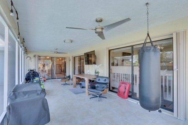 1855 Lotus Ln, Wellington, FL 33414 - sunroom with a ceiling fan, a textured ceiling, and tile patterned floors