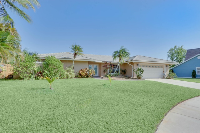 1855 Lotus Ln, Wellington, FL 33414 - ranch-style home with a garage, a front yard, driveway, and stucco siding