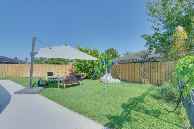 1855 Lotus Ln, Wellington, FL 33414 - view of yard featuring a playground and a patio