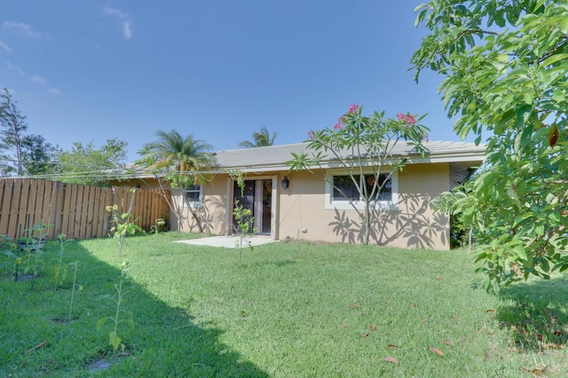 1855 Lotus Ln, Wellington, FL 33414 - rear view of property featuring stucco siding