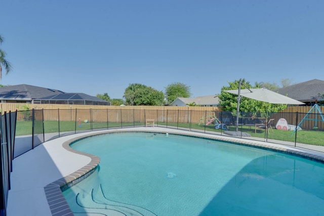 1855 Lotus Ln, Wellington, FL 33414 - view of swimming pool with a playground and a fenced backyard