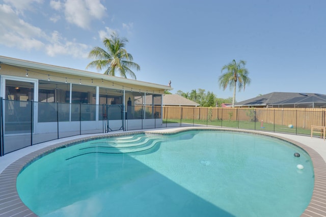 1855 Lotus Ln, Wellington, FL 33414 - view of swimming pool with a sunroom