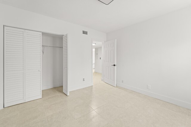 9500 SW 3rd St SW Unit 130, Boca Raton, FL 33428 - unfurnished bedroom with a closet, baseboards, and light tile patterned floors