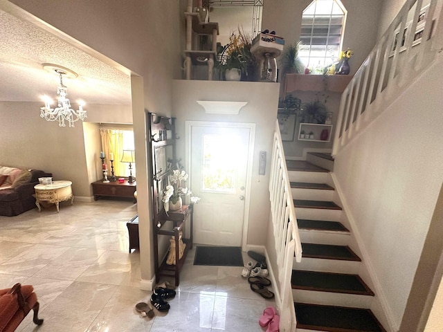 5473 E Berry Blossom Way E, West Palm Beach, FL 33415 - entryway featuring stairway, baseboards, a chandelier, and a high ceiling