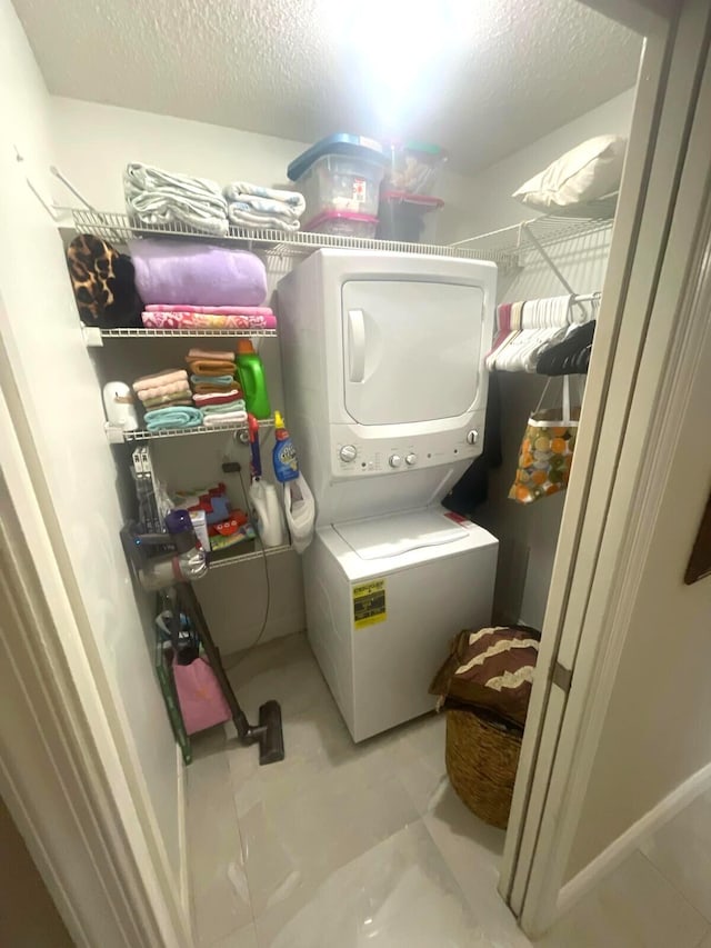 5473 E Berry Blossom Way E, West Palm Beach, FL 33415 - laundry room with estacked washer and dryer and a textured ceiling