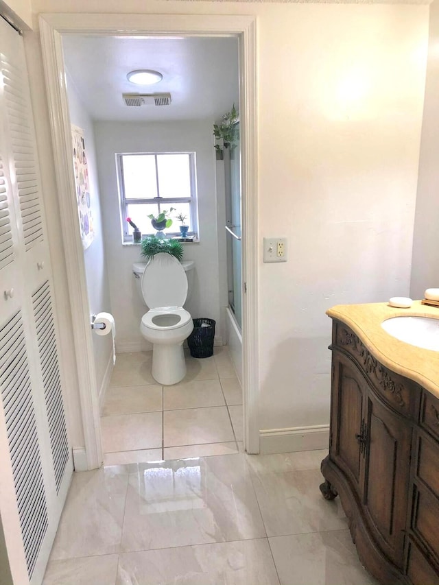 5473 E Berry Blossom Way E, West Palm Beach, FL 33415 - full bathroom with toilet, vanity, baseboards, and marble look tile flooring