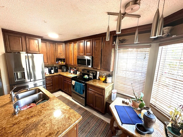 5473 E Berry Blossom Way E, West Palm Beach, FL 33415 - kitchen with appliances with stainless steel finishes, a sink, a textured ceiling, decorative light fixtures, and decorative backsplash