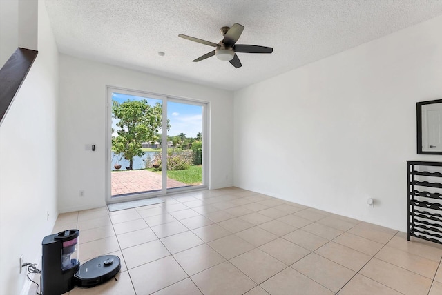 3769 Pebblebrook Ct, Coconut Creek, FL 33073 - unfurnished living room featuring ceiling fan, a textured ceiling, and light tile patterned floors