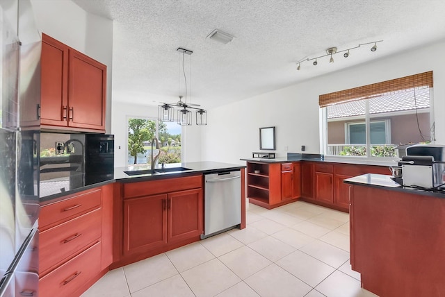3769 Pebblebrook Ct, Coconut Creek, FL 33073 - kitchen featuring stainless steel appliances, a peninsula, a sink, dark countertops, and a textured ceiling