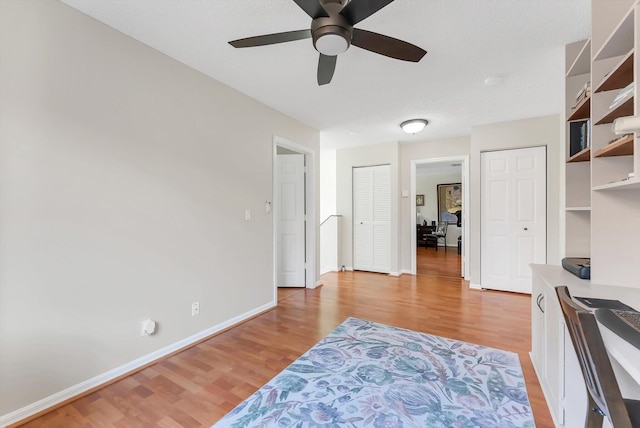 3769 Pebblebrook Ct, Coconut Creek, FL 33073 - bedroom with light wood-style flooring, two closets, baseboards, and a ceiling fan