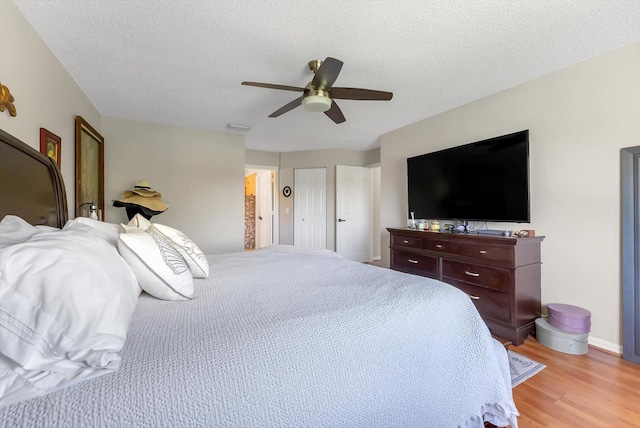3769 Pebblebrook Ct, Coconut Creek, FL 33073 - bedroom featuring light wood-type flooring, a ceiling fan, a textured ceiling, and baseboards
