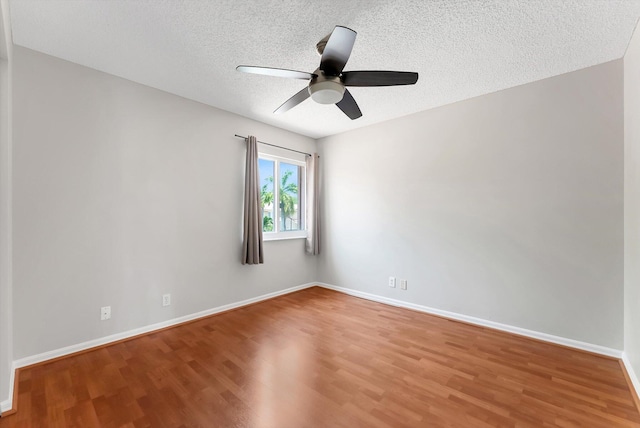 3769 Pebblebrook Ct, Coconut Creek, FL 33073 - empty room featuring wood finished floors, ceiling fan, baseboards, and a textured ceiling