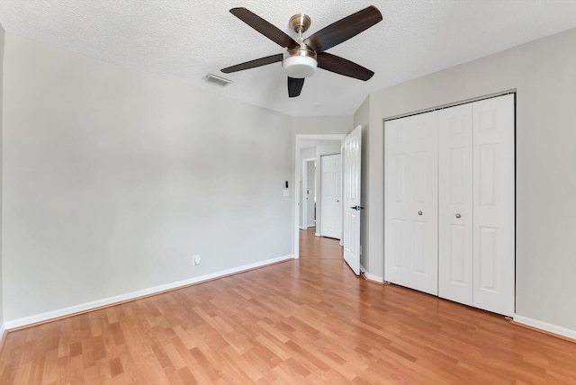 3769 Pebblebrook Ct, Coconut Creek, FL 33073 - unfurnished bedroom featuring light wood finished floors, baseboards, a textured ceiling, a closet, and a ceiling fan
