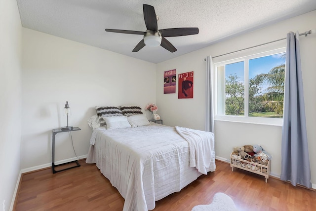3769 Pebblebrook Ct, Coconut Creek, FL 33073 - bedroom featuring wood finished floors, ceiling fan, baseboards, and a textured ceiling