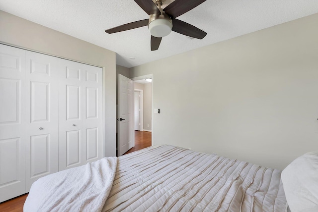 3769 Pebblebrook Ct, Coconut Creek, FL 33073 - bedroom with dark wood finished floors, a closet, ceiling fan, and a textured ceiling