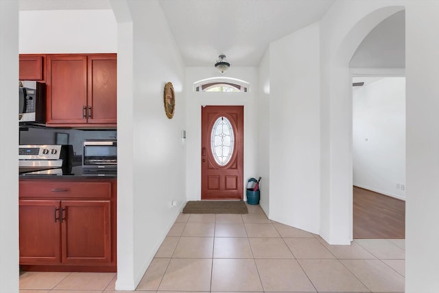 3769 Pebblebrook Ct, Coconut Creek, FL 33073 - entrance foyer featuring arched walkways, light tile patterned floors, and baseboards