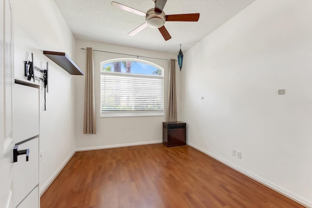 3769 Pebblebrook Ct, Coconut Creek, FL 33073 - unfurnished room featuring wood finished floors, a textured ceiling, a ceiling fan, and baseboards