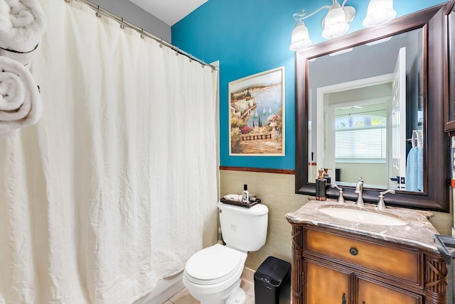 3769 Pebblebrook Ct, Coconut Creek, FL 33073 - bathroom featuring toilet, vanity, a wainscoted wall, a shower with curtain, and tile walls