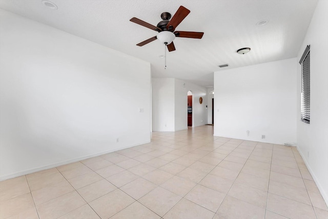 3769 Pebblebrook Ct, Coconut Creek, FL 33073 - empty room featuring a ceiling fan, arched walkways, and light tile patterned floors