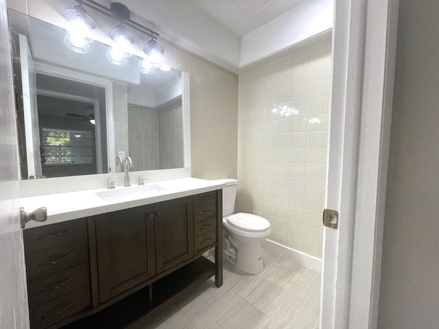 222 Piedmont E, Delray Beach, FL 33484 - bathroom with toilet, vanity, and tile walls