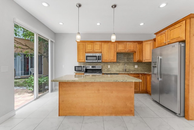 5814 Eagle Cay Ln, Coconut Creek, FL 33073 - kitchen with appliances with stainless steel finishes, a sink, backsplash, a center island, and light stone counters