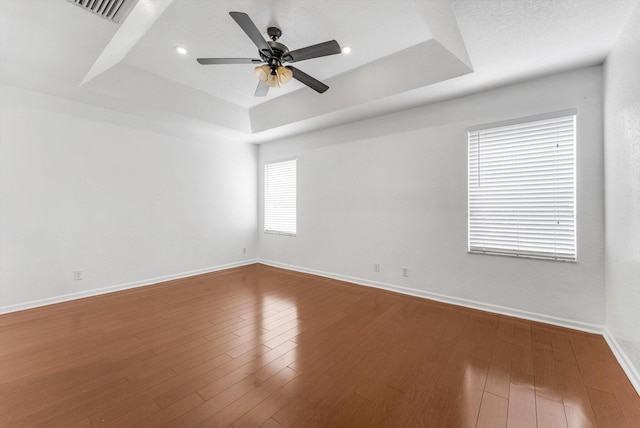 5814 Eagle Cay Ln, Coconut Creek, FL 33073 - spare room featuring a tray ceiling, ceiling fan, baseboards, and wood finished floors