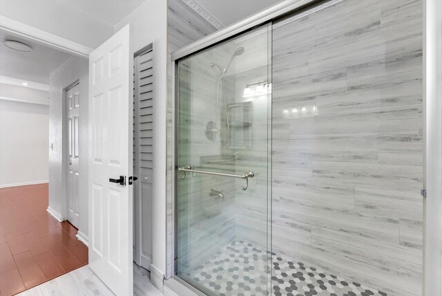 5814 Eagle Cay Ln, Coconut Creek, FL 33073 - bathroom with a shower stall, baseboards, and wood finished floors