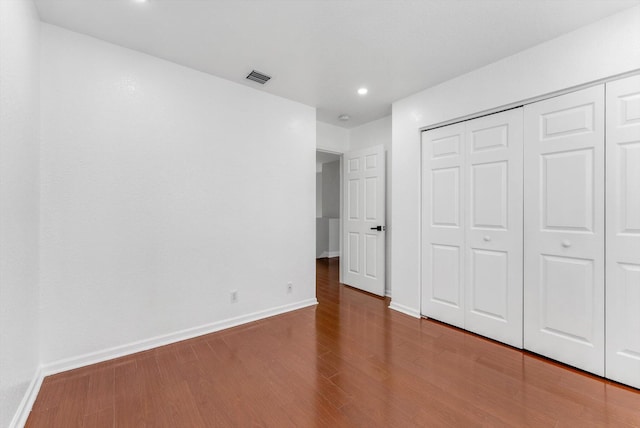 5814 Eagle Cay Ln, Coconut Creek, FL 33073 - unfurnished bedroom with baseboards, wood finished floors, a closet, and recessed lighting