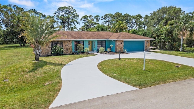 5706 Eagle Dr, Fort Pierce, FL 34950 - view of front of property featuring curved driveway, an attached garage, and a front yard
