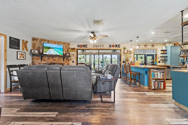 5706 Eagle Dr, Fort Pierce, FL 34950 - living area featuring wood finished floors, ceiling fan, and a textured ceiling