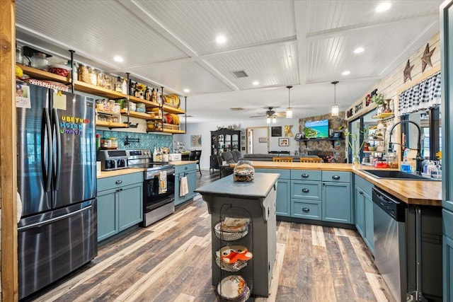 5706 Eagle Dr, Fort Pierce, FL 34950 - kitchen with appliances with stainless steel finishes, butcher block counters, a sink, wood finished floors, and open shelves