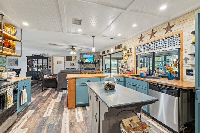 5706 Eagle Dr, Fort Pierce, FL 34950 - kitchen featuring butcher block countertops, appliances with stainless steel finishes, a sink, light wood-style flooring, and recessed lighting
